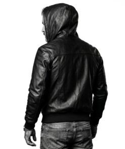Rear view of a man in the Nintenzo black hooded leather bomber jacket with the hood up, showing the full-grain texture.