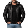 Front of a bearded man wearing the zipped Nintenzo black leather hooded bomber jacket with tattooed hands in pockets.